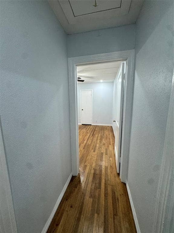 8105 White Settlement Road, White Settlement, TX 76108 Hallway featuring warm wood-finish flooring, soft neutral wall paint, and recessed ceiling lighting