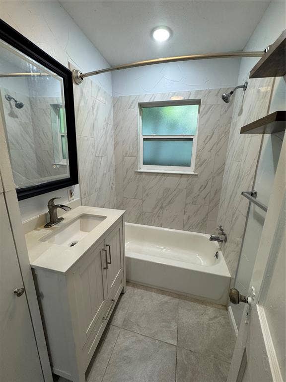 8105 White Settlement Road, White Settlement, TX 76108 Newly renovated bathroom featuring a white vanity with single-sink configuration, quartz countertop, polished chrome faucet, and large mirror with black frame
