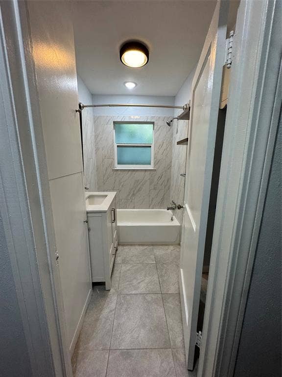 8105 White Settlement Road, White Settlement, TX 76108 Modern primary bathroom featuring marble-look tile flooring and wall surround, a frameless glass shower enclosure with chrome hardware, an integrated soaking tub, recessed ceiling lighting, and a window for natural light