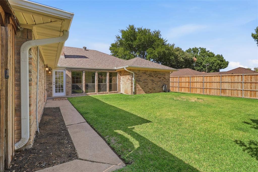 2808 Fountain Head Drive, Plano, TX 75023 Expansive grassy yard with a wood privacy fence