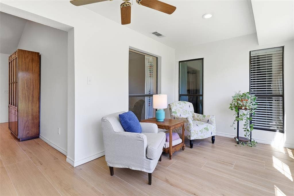 2808 Fountain Head Drive, Plano, TX 75023 Wood-finish flooring throughout, bright white walls, recessed lighting, and a ceiling fan with integrated lighting