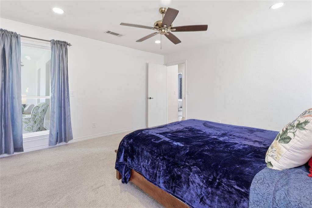 2808 Fountain Head Drive, Plano, TX 75023 Spacious master bedroom featuring a ceiling fan, recessed lighting, and soft carpet flooring