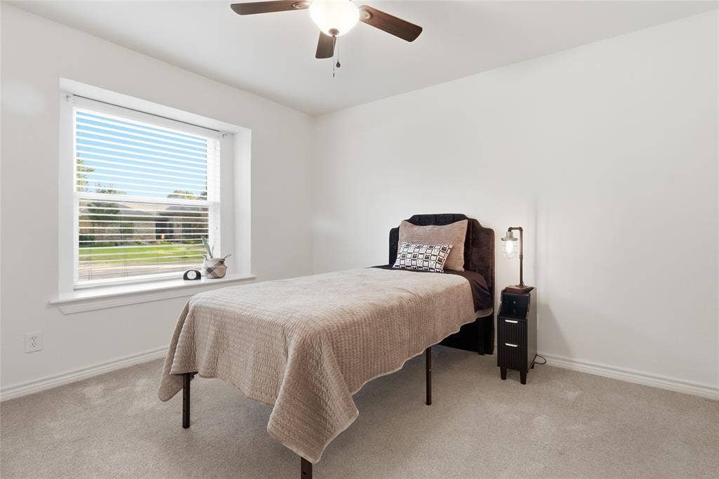 2808 Fountain Head Drive, Plano, TX 75023 Carpeted room with a ceiling fan and a window featuring horizontal blinds