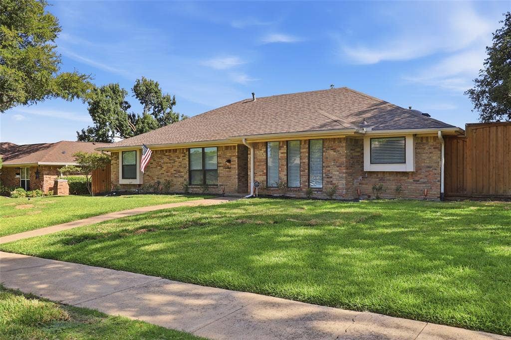 2808 Fountain Head Drive, Plano, TX 75023 Brick exterior, pitched shingle roof, established front lawn, concrete walkway, and privacy fencing