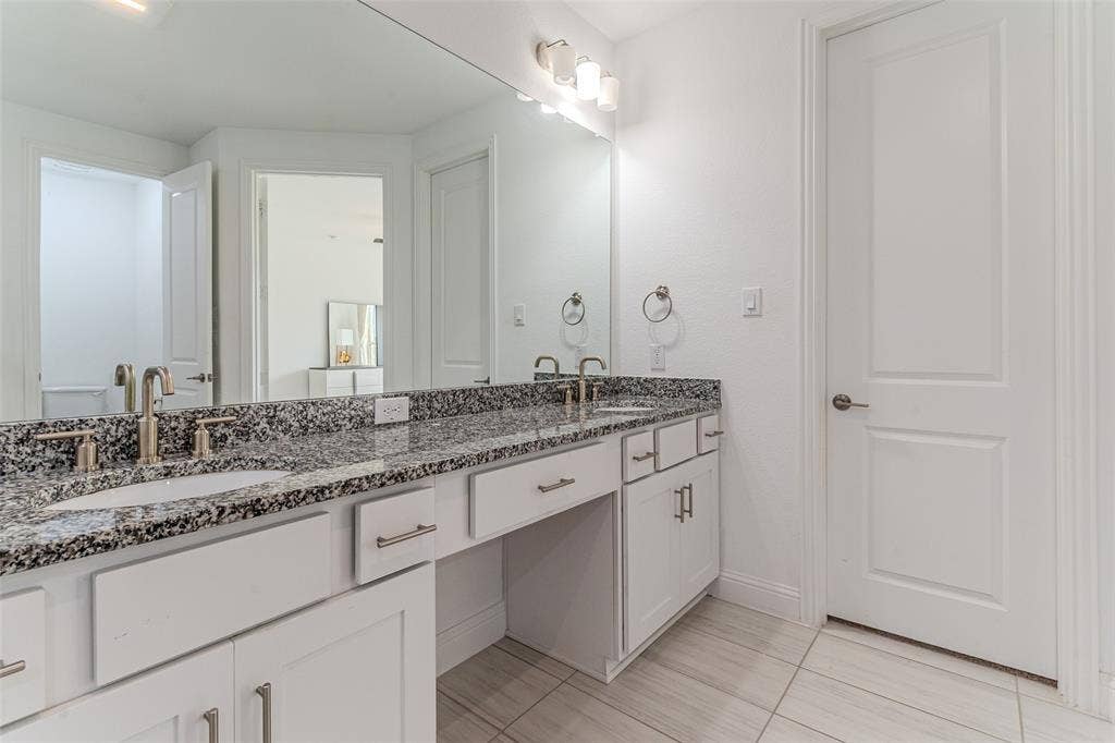 2515 Bedford Road, Northlake, TX 76226 Double vanity featuring stone countertops, undermount sinks, and brushed nickel fixtures