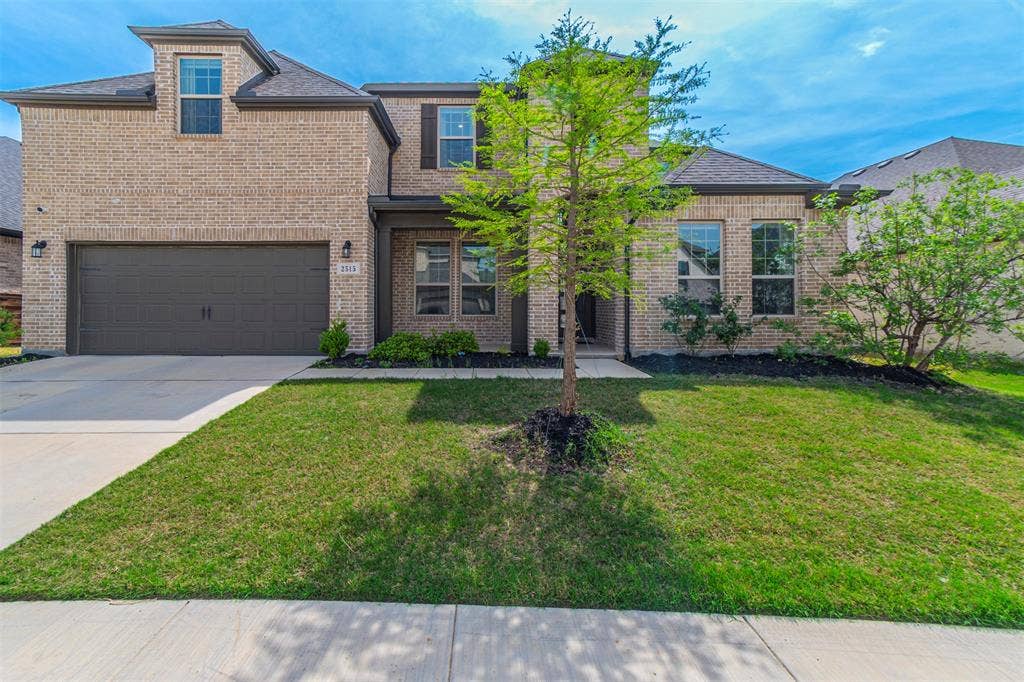 2515 Bedford Road, Northlake, TX 76226 Brick facade with dark trim accents, integrated two-car garage, dormer window, and mature front landscaping