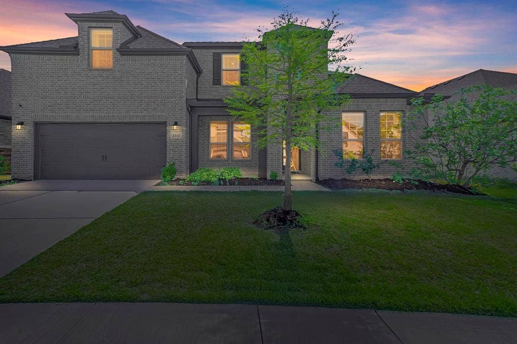 2515 Bedford Road, Northlake, TX 76226 Two-story residence featuring brick exterior, attached two-car garage, front yard with mature landscaping, and an inviting entryway