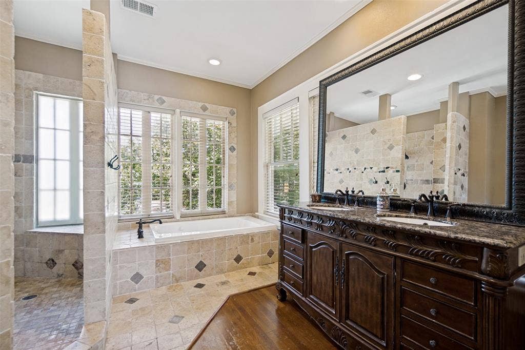 5610 Gaston Avenue, Dallas, TX 75214 Dual vanity with dark wood cabinetry and stone countertop