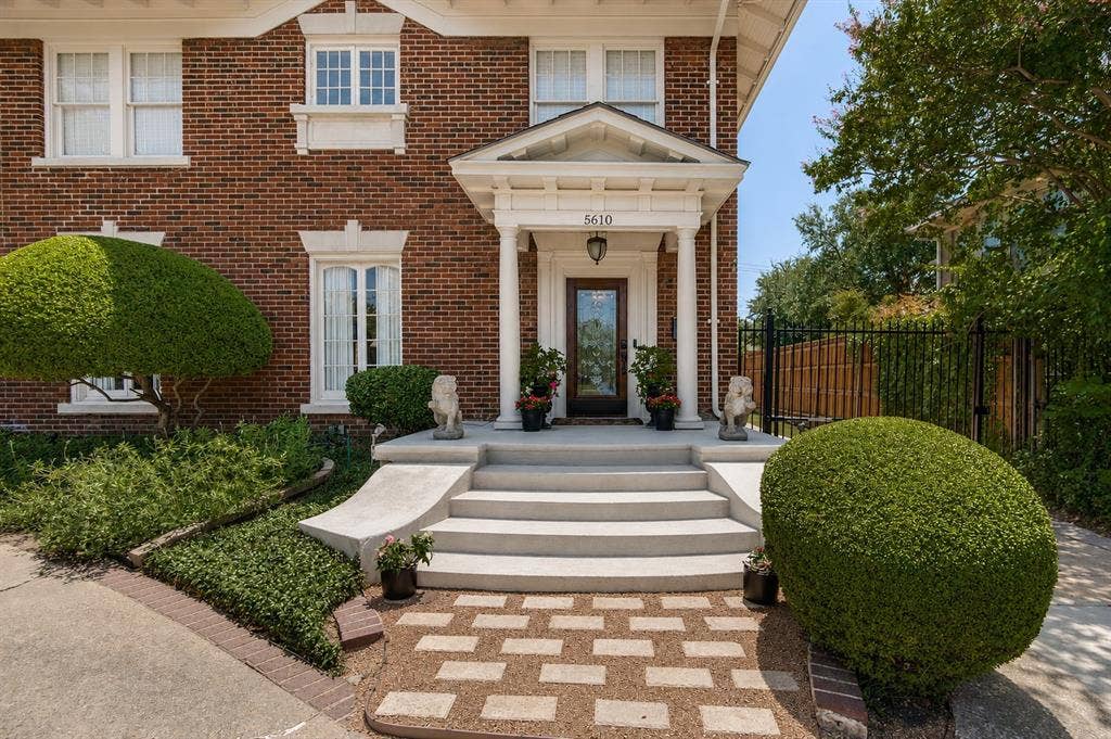 5610 Gaston Avenue, Dallas, TX 75214 Brick exterior with stone window sills, a covered entry with columns, and concrete stairs