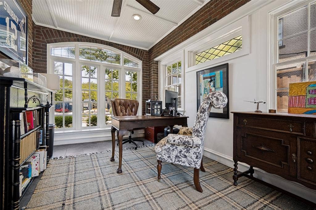 5610 Gaston Avenue, Dallas, TX 75214 Room featuring brick walls, a white beadboard ceiling, and light-colored flooring