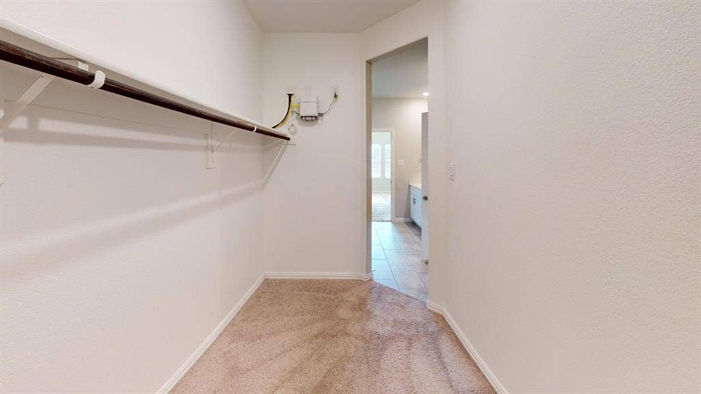 1508 Lannon Lane, Melissa, TX 75454 Carpeted walk-in closet with built-in shelving and hanging rod