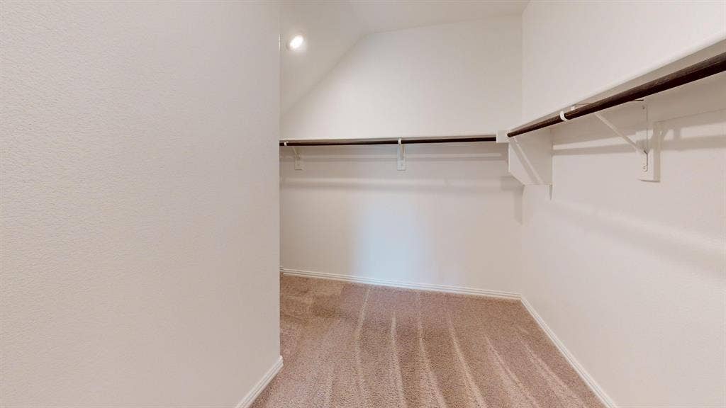 1508 Lannon Lane, Melissa, TX 75454 Neutral-toned carpeting, white walls, built-in shelving, and clothes rods