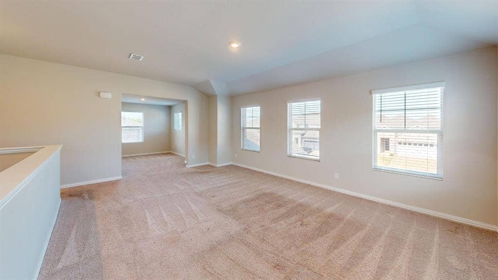 1508 Lannon Lane, Melissa, TX 75454 Expansive carpeted area featuring light neutral wall tones, multiple windows with blinds, and recessed lighting