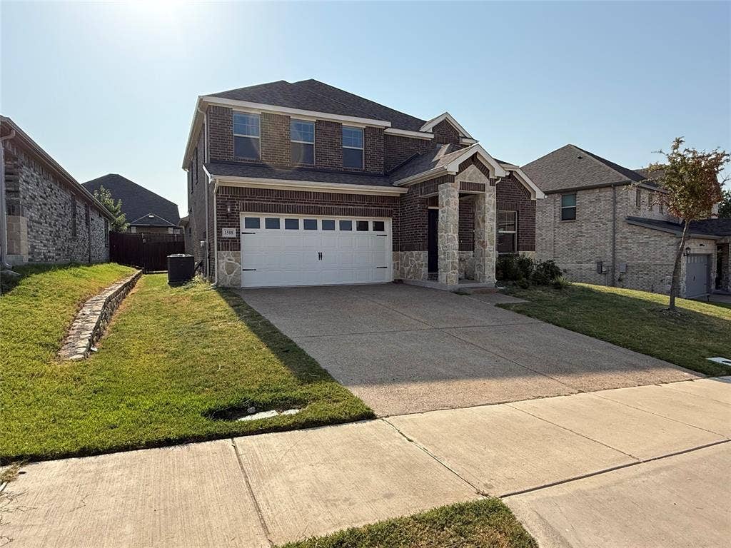 1508 Lannon Lane, Melissa, TX 75454 Brick and stone exterior with a two-car garage, concrete driveway, and front lawn