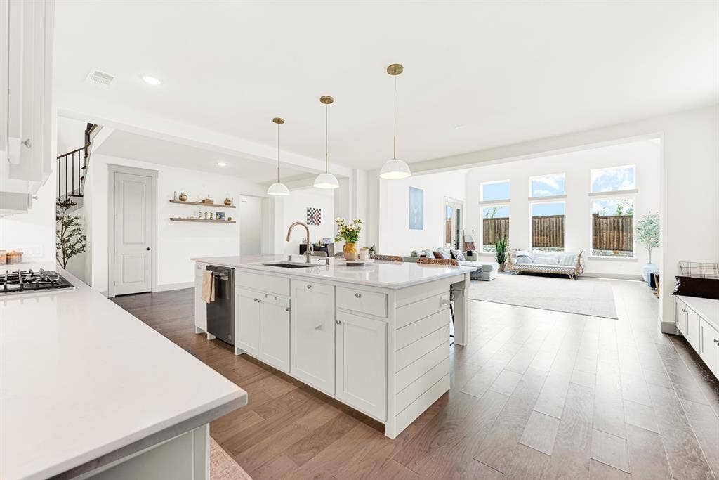 10067 Clover Forest Court, Frisco, TX 75035 Expansive open-concept layout connects the main cooking hub seamlessly to light-filled adjacent spaces. Perfect for hosting big holiday parties without missing any conversation.