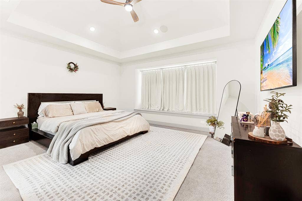 10067 Clover Forest Court, Frisco, TX 75035 A tray ceiling adds vertical dimension over a wide window niche that filters soft ambient light. It’s a peaceful haven to unwind with late-night television after a busy afternoon