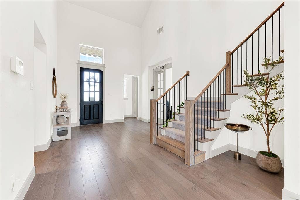 10067 Clover Forest Court, Frisco, TX 75035 A grand, soaring ceiling pairs with a glass-paneled front door that floods the light wood floors with soft natural sunshine. It’s the perfect spot to kick off your shoes and welcome family home after a long day.