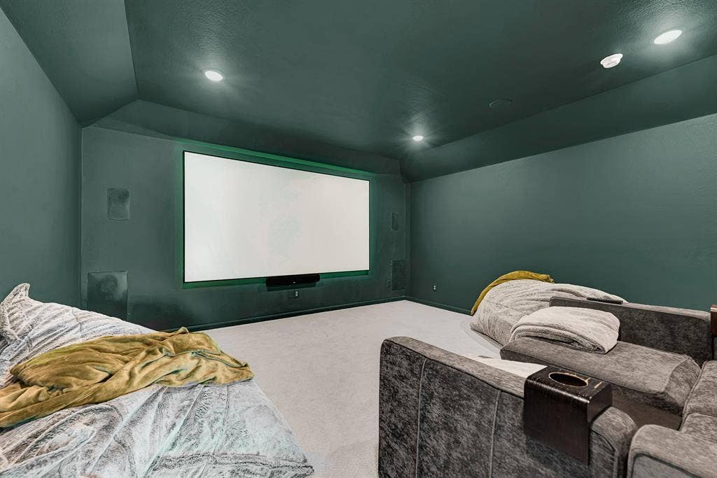 10067 Clover Forest Court, Frisco, TX 75035 Deep moody walls and subtle backlighting surround a focal projection wall for a sleek cinema look. You can dim the overhead lights and immerse yourself in an epic Friday movie marathon with fresh popcorn.
