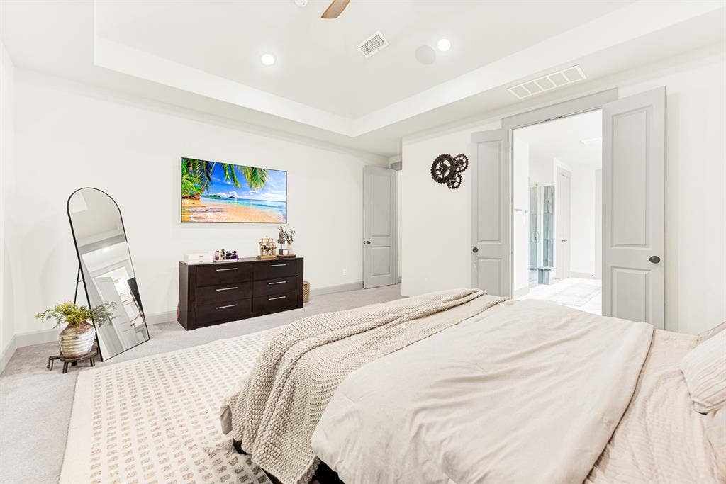 10067 Clover Forest Court, Frisco, TX 75035 Double entry doors open directly into the connected bath retreat across a vast carpeted footprint. Picture waking up refreshed and strolling straight into your private morning routine.
