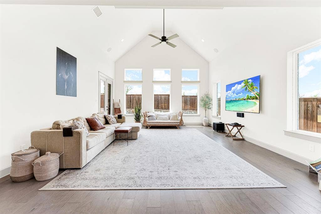 10067 Clover Forest Court, Frisco, TX 75035 Dramatic cathedral ceilings and a trio of tall rear windows draw sunshine deep into the spacious room. It’s a cozy setting for family movie nights or curling up with a good book.