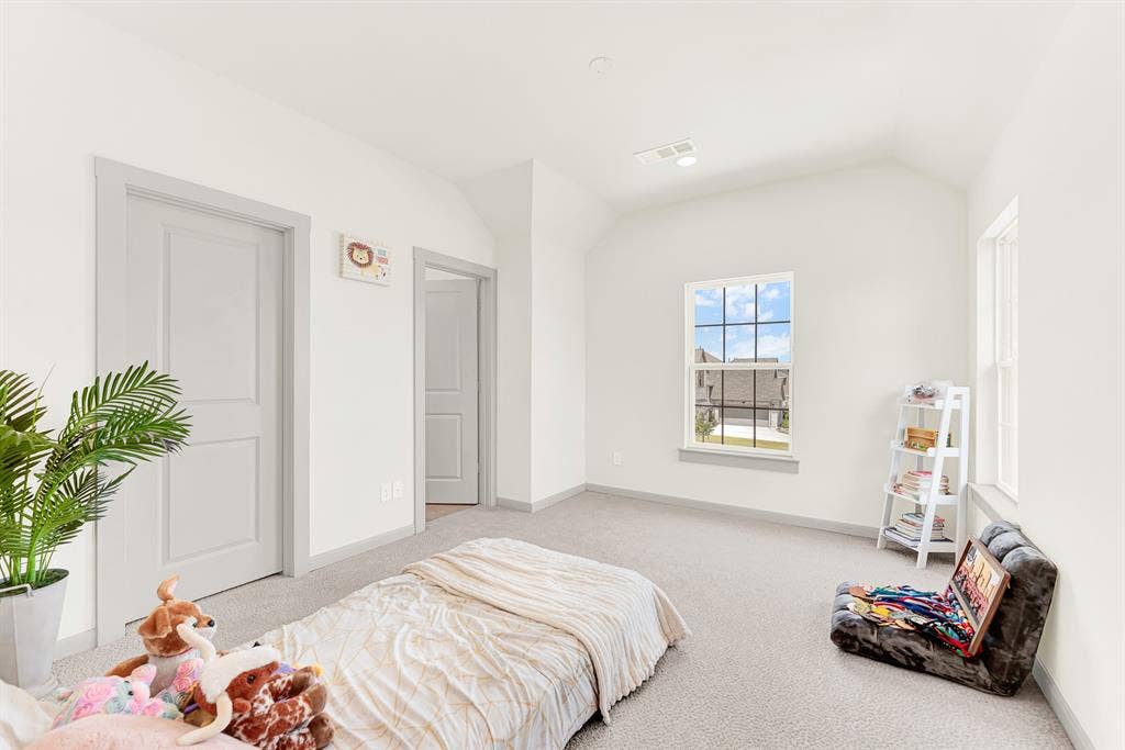 10067 Clover Forest Court, Frisco, TX 75035 Dual-aspect windows frame neighborhood views while drawing balanced daylight across the geometric wall corners. Younger kids can spread out toys for imaginative floor play in their own cozy haven.