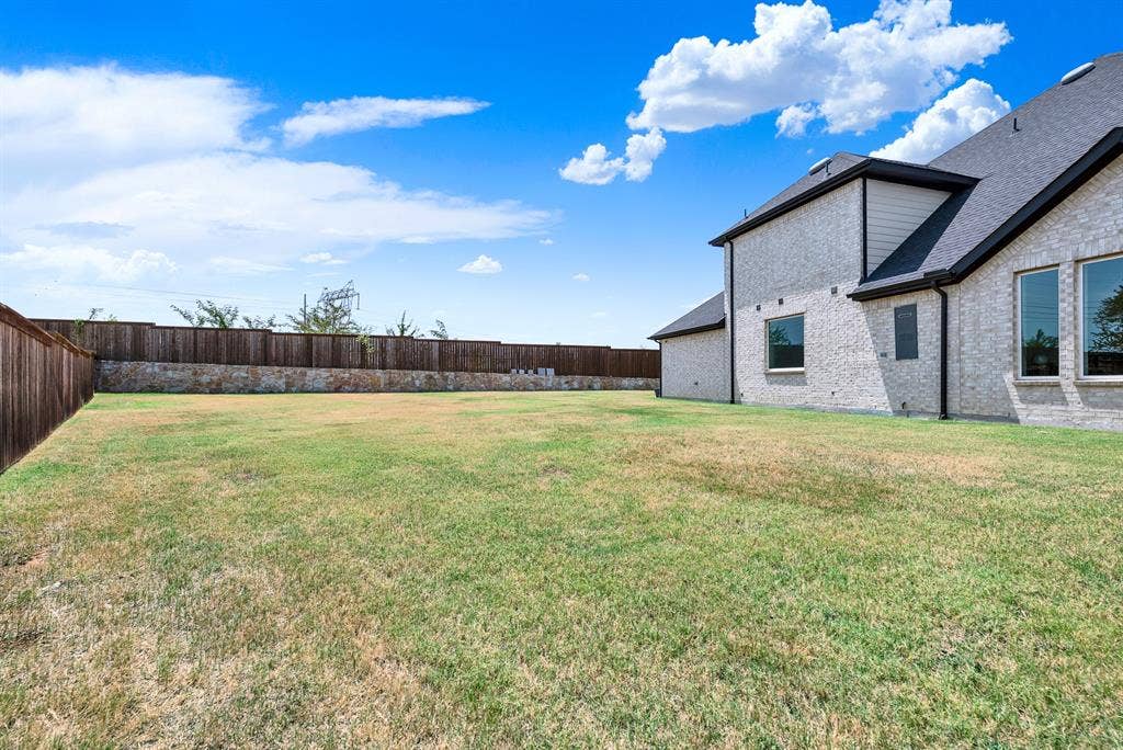 10067 Clover Forest Court, Frisco, TX 75035 Sweeping rooflines and light brick walls stretch across an impressively wide, flat green expanse. It offers the ideal canvas for hosting lively weekend barbecues with plenty of space for everyone.