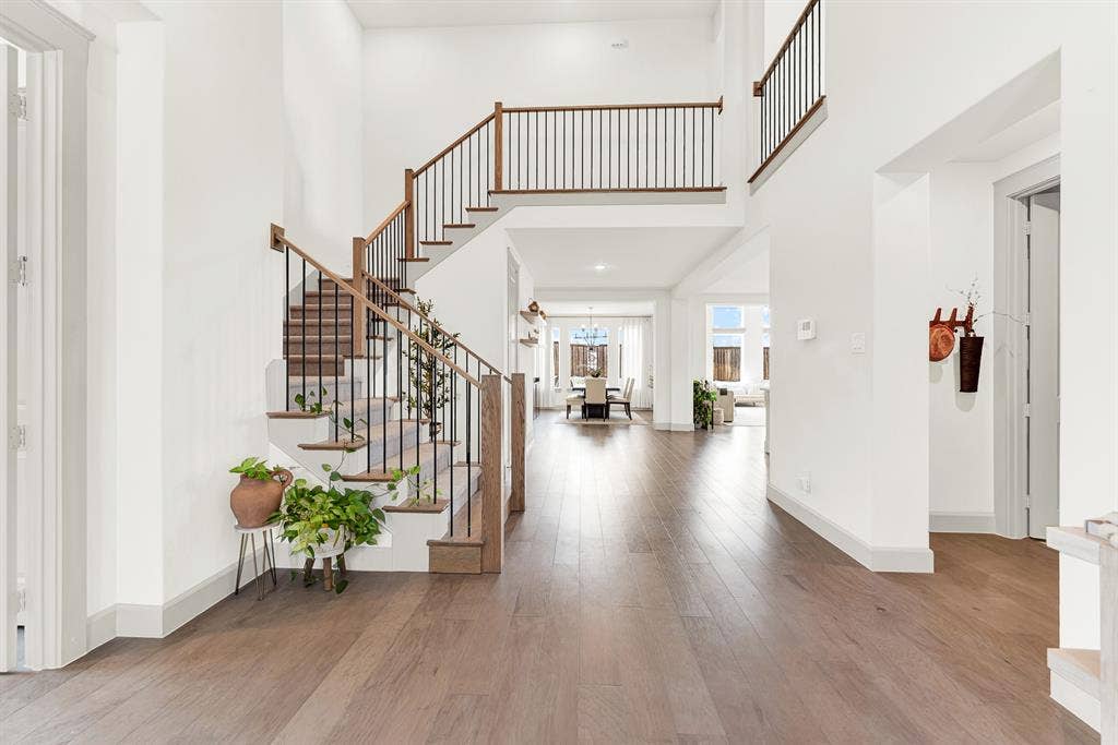 10067 Clover Forest Court, Frisco, TX 75035 Slender iron balusters and a wrapping upper gallery create an open, airy flow down into the main living spaces below. Imagine stepping down the stairs on a quiet weekend morning, greeted by the comforting smell of fresh coffee brewing nearby