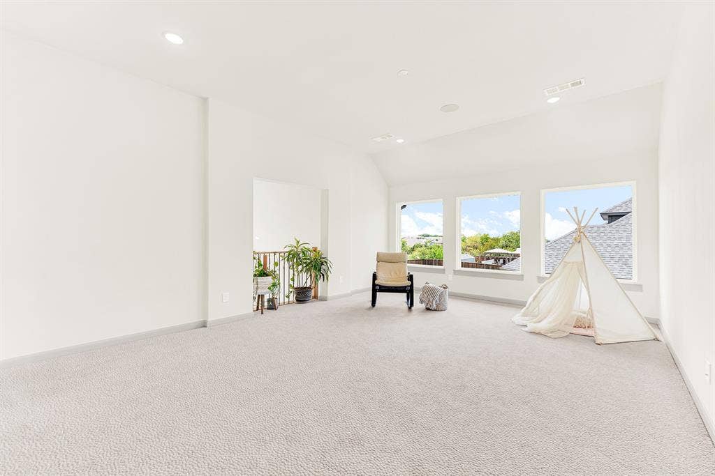 10067 Clover Forest Court, Frisco, TX 75035 A trio of large windows fills the vaulted space with daylight and open sky views. Kids and adults alike can spend easy weekend afternoons playing board games bathed in warm sunshine