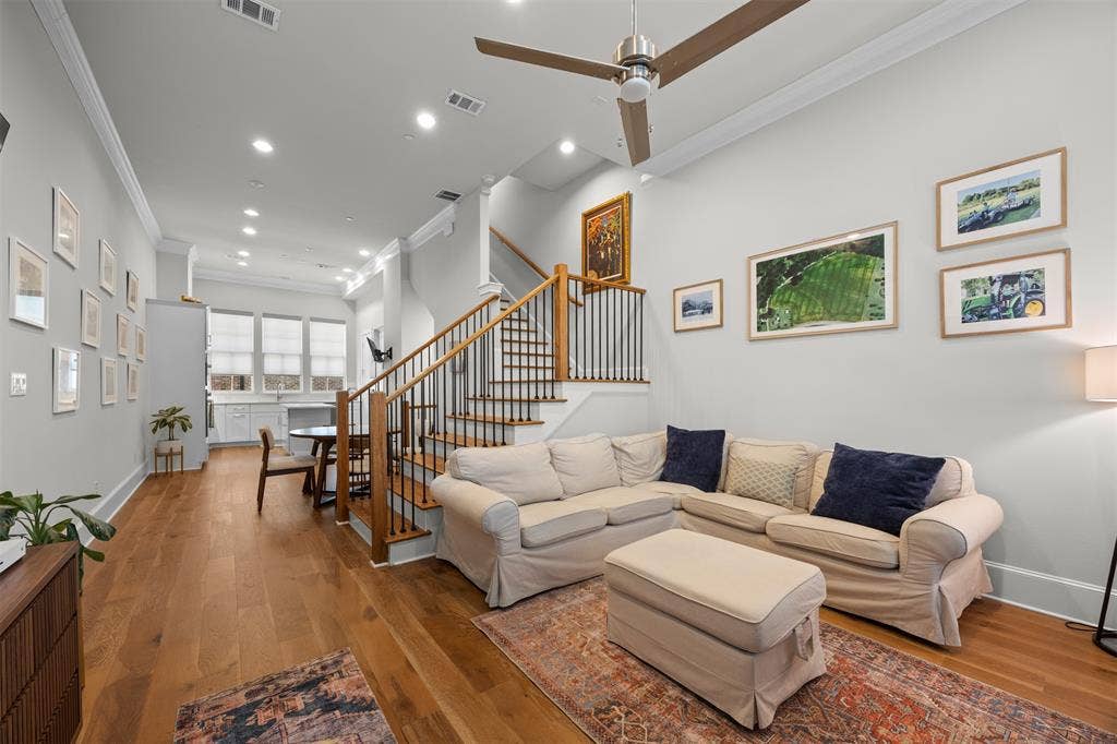 Hardwood flooring with a contemporary ceiling fan and recessed lighting