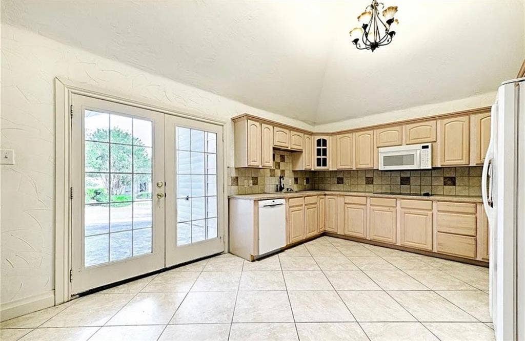 2601 Country Place, Carrollton, TX 75006 Spacious kitchen featuring wood-finish cabinetry, tile flooring, and stainless steel appliances