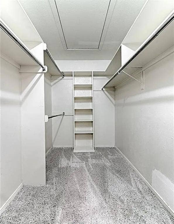 2601 Country Place, Carrollton, TX 75006 Organized closet featuring a built-in shelving unit, multiple hanging rods, and light-colored carpet flooring