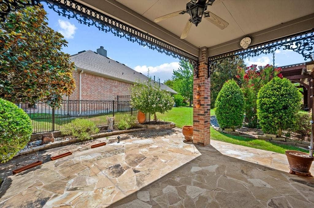 929 Oakland Hills Drive, Fairview, TX 75069 Extended flagstone patio, ceiling fan, decorative ceiling, trees and shrubs provide privacy