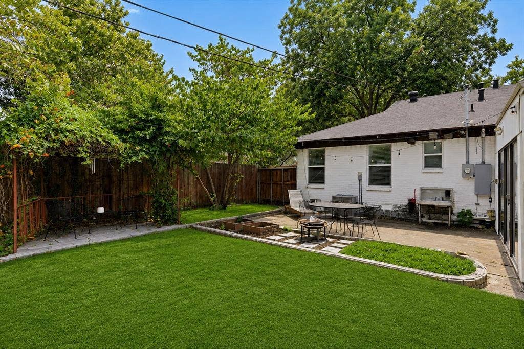 3111 Rotan Lane, Dallas, TX 75229 Expansive backyard with great patio. Grass has been digitally enhanced to be greener.