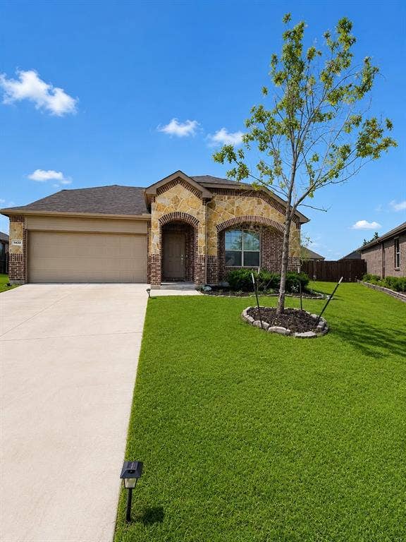 8432 Butterfly Lane, McKinney, TX 75071 Elegant brick and stone exterior with arched entryway and multi-pane windows