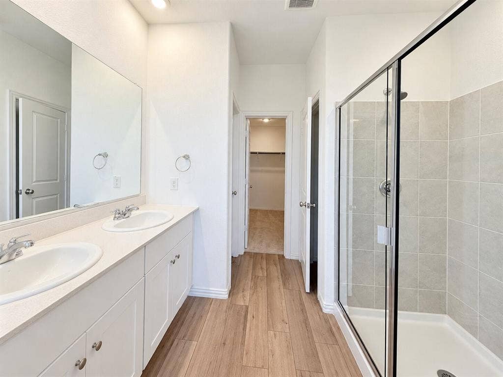8432 Butterfly Lane, McKinney, TX 75071 Dual vanity with white cabinetry, light-toned countertop, and undermount sinks