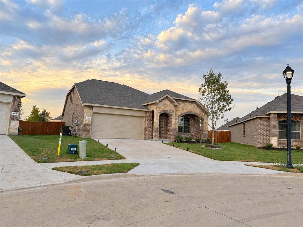 8432 Butterfly Lane, McKinney, TX 75071 Stone and brick exterior with a dark shingle roof