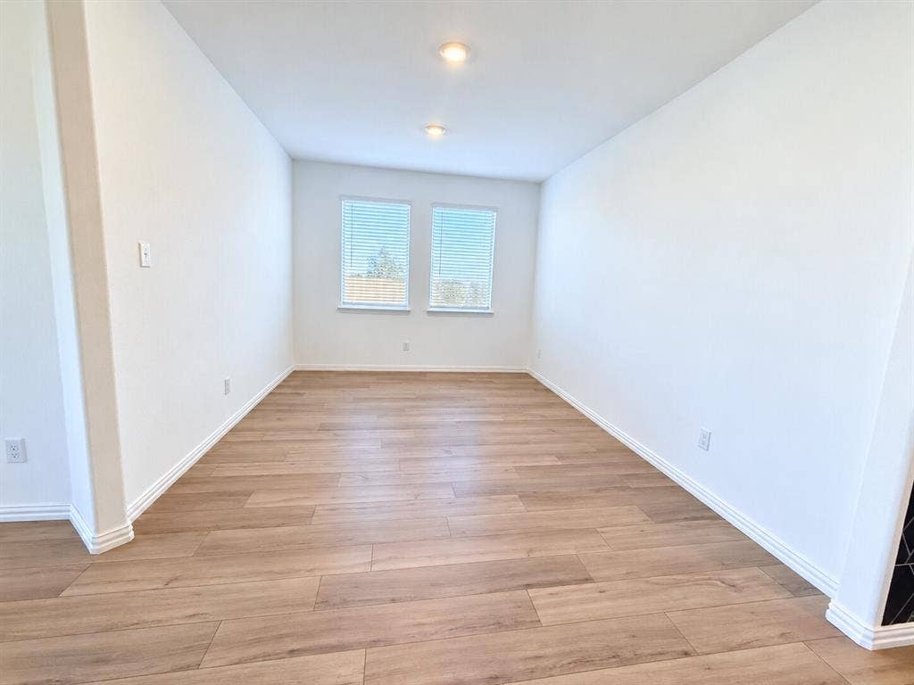8432 Butterfly Lane, McKinney, TX 75071 Wood-finish flooring, recessed lighting, and dual windows with blinds