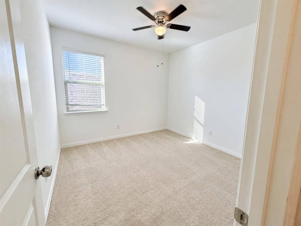 8432 Butterfly Lane, McKinney, TX 75071 Neutral tone carpeting, single window with blinds, ceiling fan with integrated lighting, white walls
