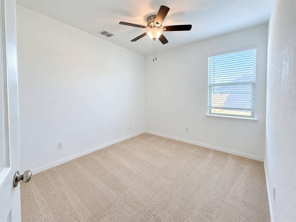 8432 Butterfly Lane, McKinney, TX 75071 Light-colored carpeting, a window with horizontal blinds, and a ceiling fan with integrated lighting