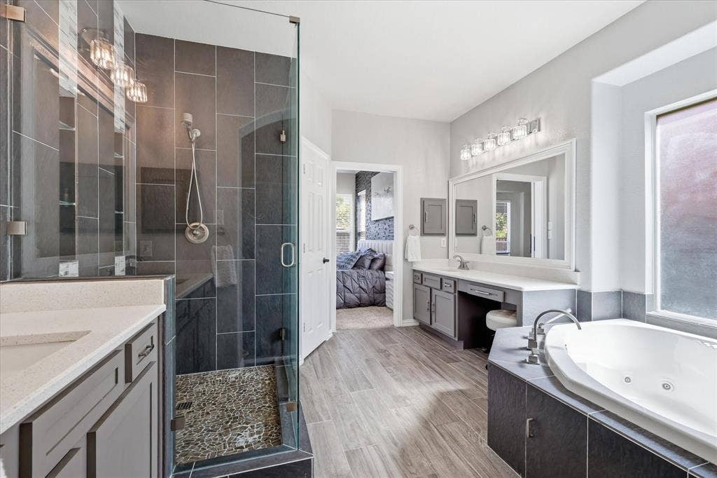Dual vanities, framed mirrors and a jetted tub