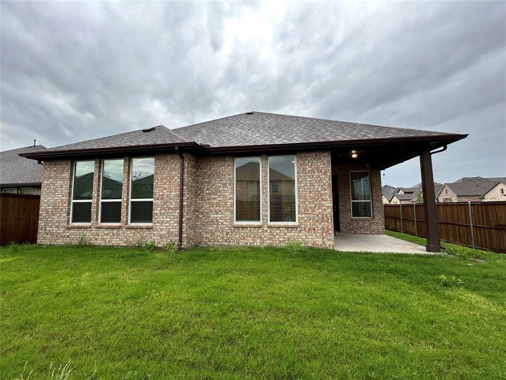3314 Willena Road, Melissa, TX 75454 Brick exterior with multiple windows, a covered patio, and a shingled roof
