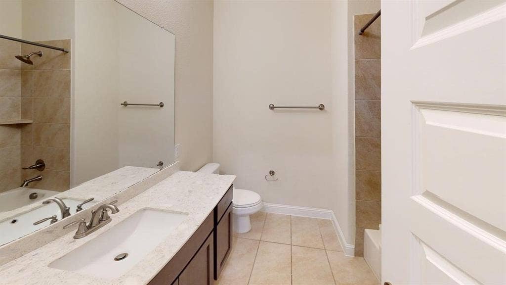 3314 Willena Road, Melissa, TX 75454 Dual vanity with marble-finish countertops and brushed nickel fixtures, ceramic tile flooring, and abundant natural lighting