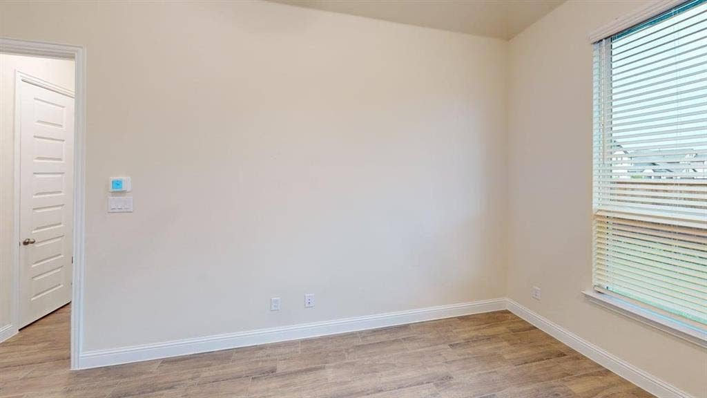 3314 Willena Road, Melissa, TX 75454 Wood-finish flooring with white trim and a window with blinds