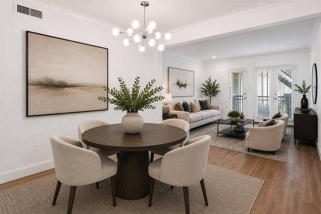 10207 Regal Oaks Drive, #109, Dallas, TX 75230 Virtually staged view highlighting the open connection between the dining and living areas, creating a comfortable layout for everyday living and entertaining.