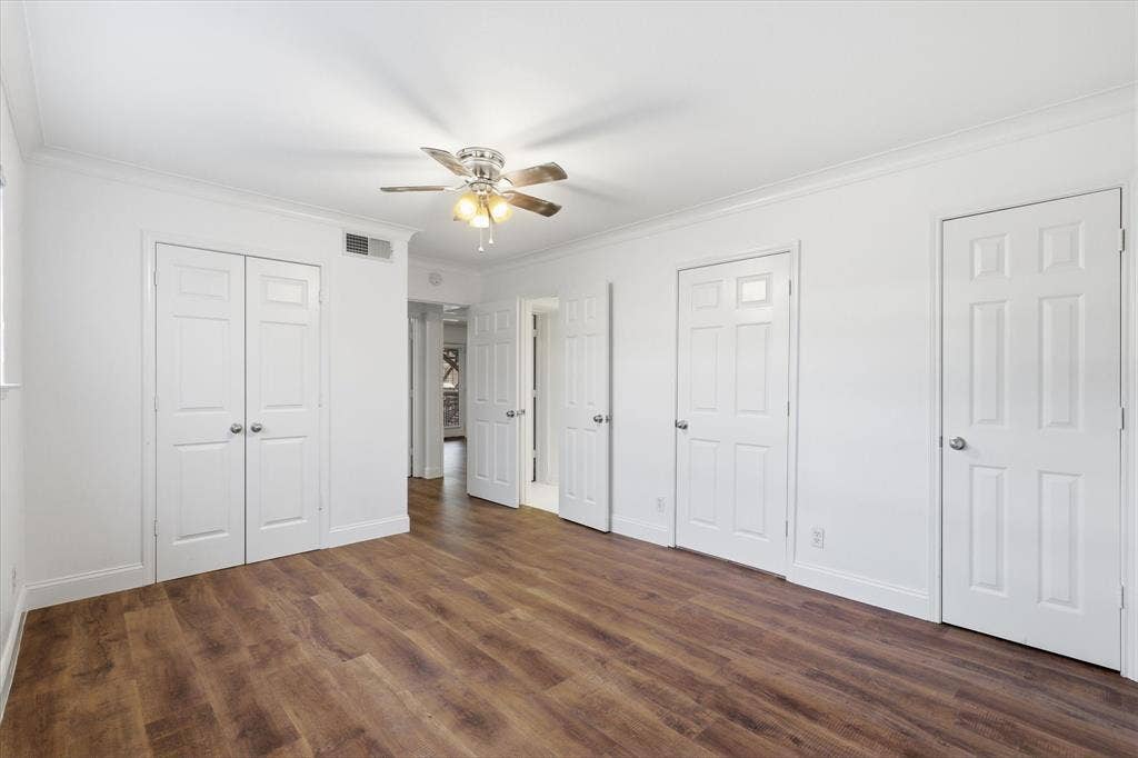 10207 Regal Oaks Drive, #109, Dallas, TX 75230 Additional primary bedroom view showing the room’s size, closet storage (2), access to utility room, bathroom and access to the adjoining hallway.