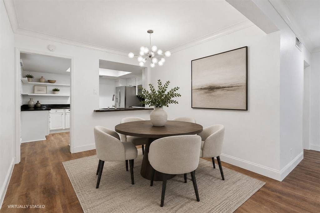 10207 Regal Oaks Drive, #109, Dallas, TX 75230 Virtually staged dining area showing its convenient connection to the kitchen and living space. The open layout allows the rooms to flow naturally together.