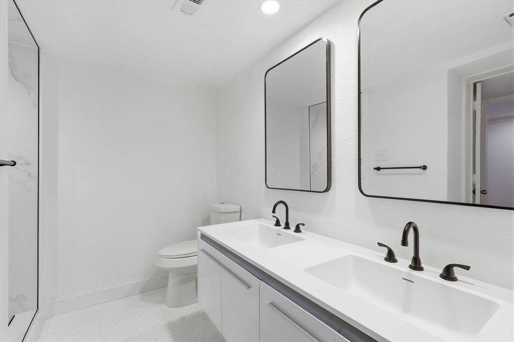10207 Regal Oaks Drive, #109, Dallas, TX 75230 Remodeled bathroom with a double vanity, updated fixtures and contemporary finishes.