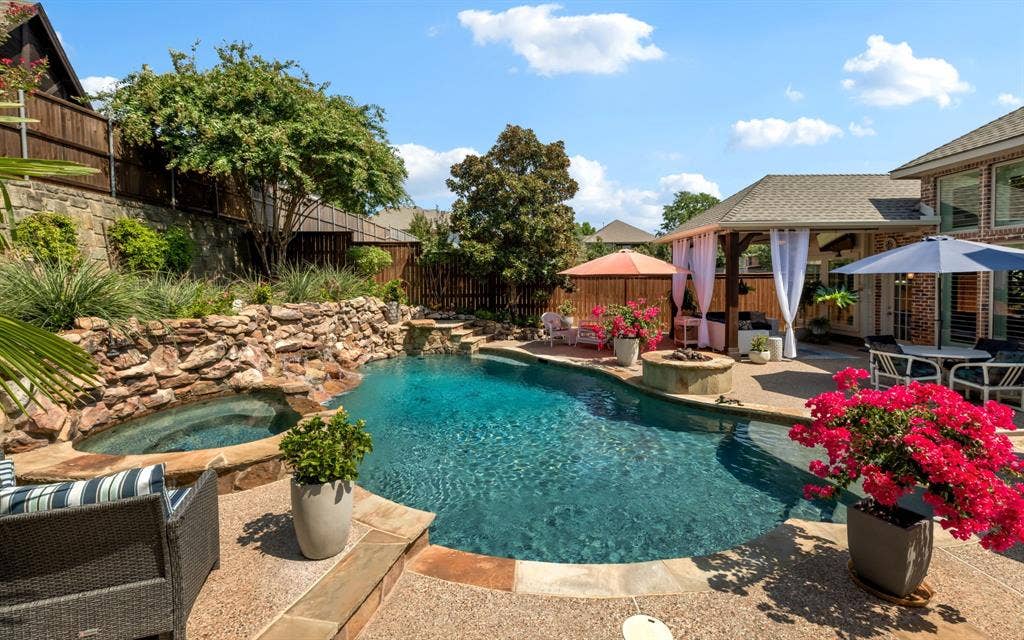 1708 Chessington Lane, McKinney, TX 75072 Spa, fire pit, water features and even a built-in diving ledge help make this fabulous back yard a place to unwind and cool off.