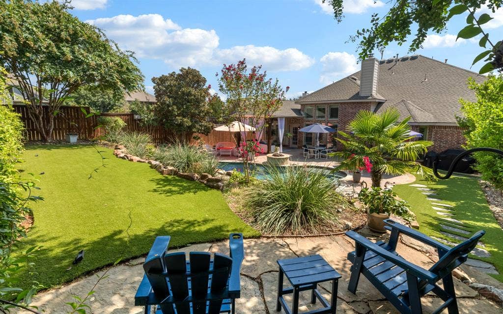 1708 Chessington Lane, McKinney, TX 75072 This is the view from the upper terrace. Synthetic turf has been installed throughout the backyard to help maintain the lush surroundings.