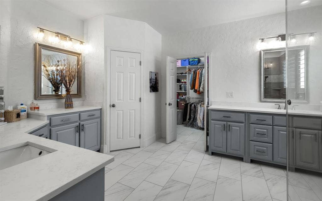 1708 Chessington Lane, McKinney, TX 75072 Large primary ensuite bath has plenty of counter space (newer quartz), flooring and a large updated walk-in shower.